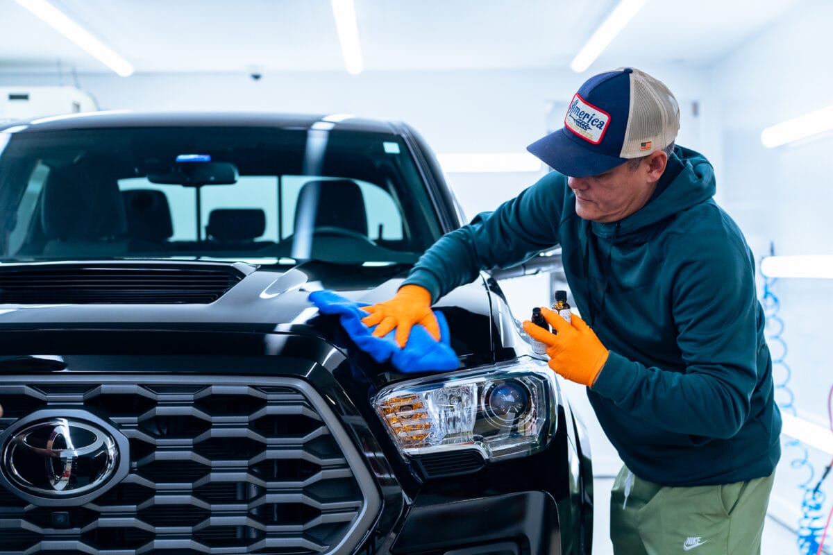 San Diego mobile detailer applying ceramic coating protection to a luxury car